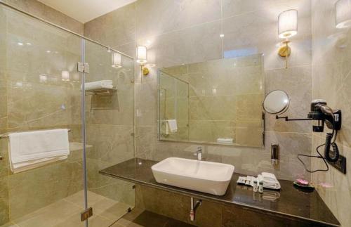 a bathroom with a sink and a mirror at The Row House Kasauli in Kasauli