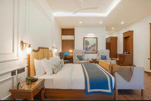 a bedroom with a bed and a living room at The Row House Kasauli in Kasauli