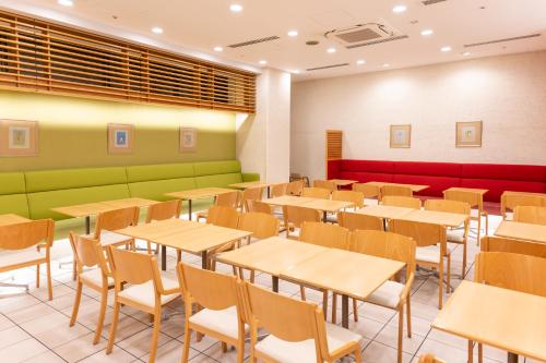 an empty dining room with tables and chairs at Hotel the Lutheran in Osaka