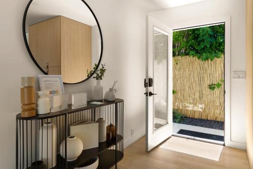 a mirror on a wall next to a door at Private Pool Escape Casita Mini Golf 4BR in Indio