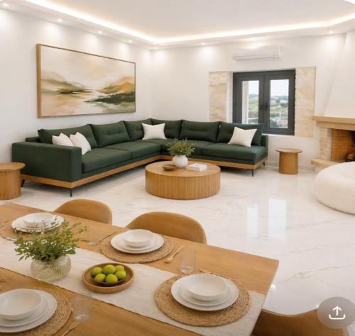 a living room with a green couch and a table at 500 sqm Private Garden, Outdoor Kitchen, near Falasarna & Balos Beach in Falasarna