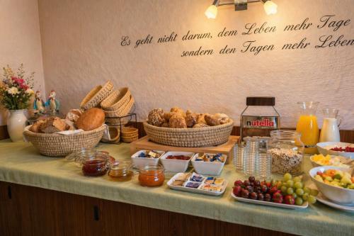 a buffet with baskets of food on a table at Grüner Baum in Bad Staffelstein