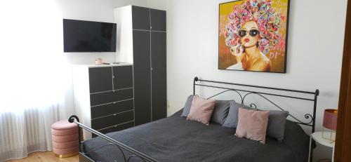 a bedroom with a bed and a painting on the wall at Haus Muigg in Innsbruck