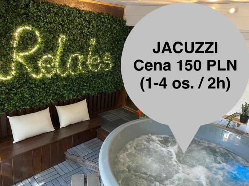 a sign that reads jacoya ciao firm with a bath tub at Apartamenty Jagodzianka - Jacuzzi, Sauna, Hot-bania, Tężnia in Ustrzyki Dolne