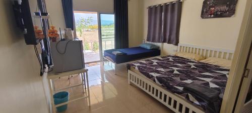 a bedroom with a bed and a television in it at ณ กาญโฮม NaKan Home in Ban Hin Hak