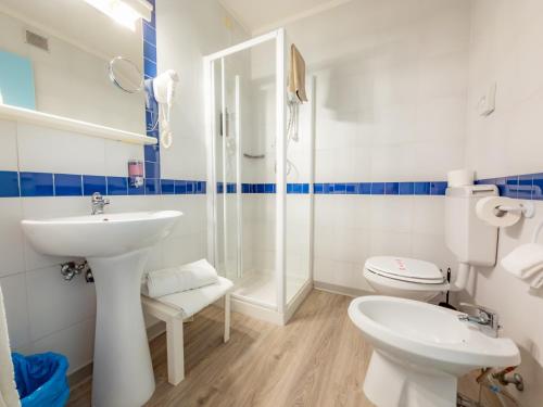 a bathroom with a sink and a toilet at Hotel Park Spiaggia in Grado