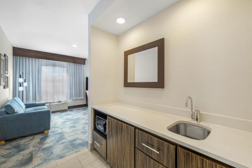 a bathroom with a sink and a couch in a room at Hampton Inn & Suites Bend in Bend