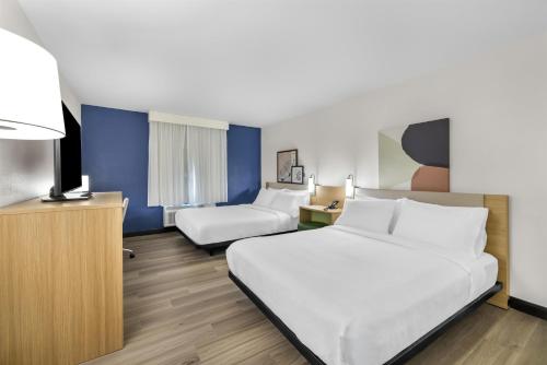 a hotel room with two beds and a tv at Spark By Hilton Hamburg in Hamburg