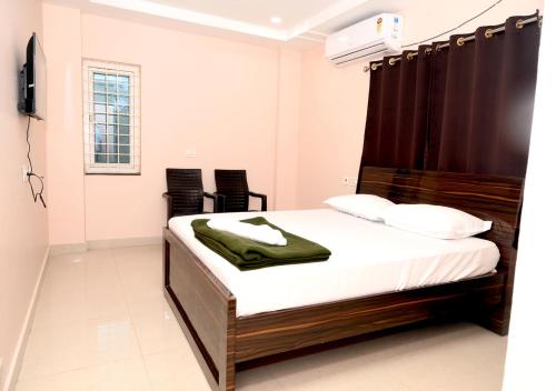 a bedroom with a bed in a room at Hotel Ram Way in Visakhapatnam