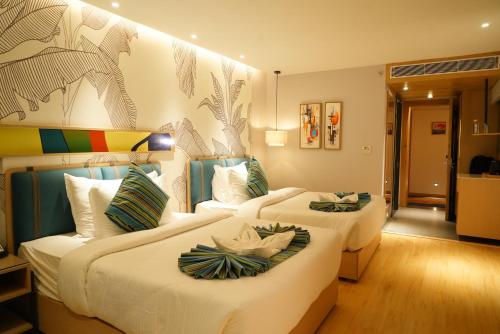 a hotel room with two beds in a room at Clarion Inn Greywall By Choice Hotels in Amritsar