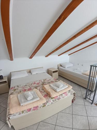 a bedroom with a bed and a bath room at Vila Vukotić in Petrovac na Moru