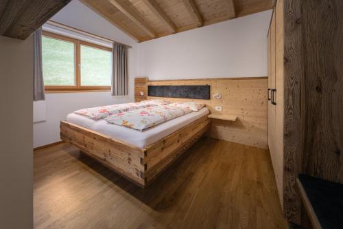 a bedroom with a large bed in a room at Schmalzlhof in Siusi