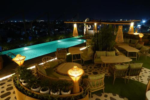 a rooftop patio with a swimming pool at night at Clarion Inn Greywall By Choice Hotels in Amritsar