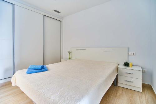 a white bedroom with a large bed and a dresser at Espanhouse Pinada Beach in La Marquesa