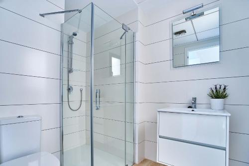 a bathroom with a glass shower and a sink at Espanhouse Pinada Beach in La Marquesa