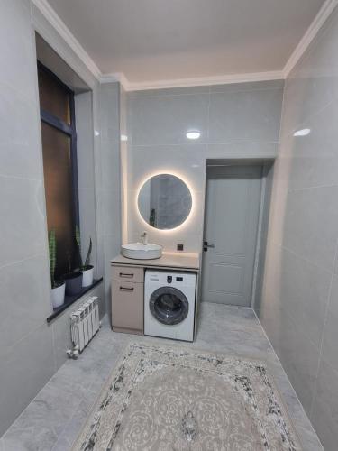 a bathroom with a washing machine and a sink at Самал 3 in Shymkent