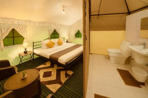 a bedroom with a bed and a bathroom at The Himalayan Swiss Cottage with Bonfire, Manali - A Riverside Retreat in Manāli