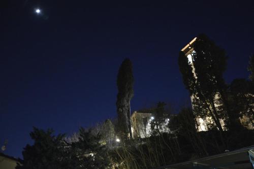 a view of a building at night with the moon at Borgo della Rocca in Montemurlo