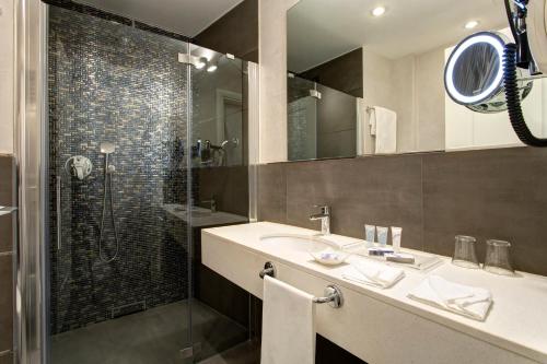 a bathroom with a sink and a shower at Hotel Nazionale in Rome