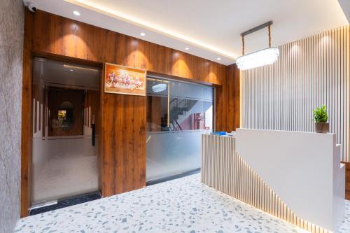 a lobby of a building with wooden walls at Mosaic Go Star Grand in Navi Mumbai
