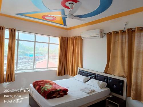 a bedroom with a bed and a ceiling at Hotel Vishal in Buxar