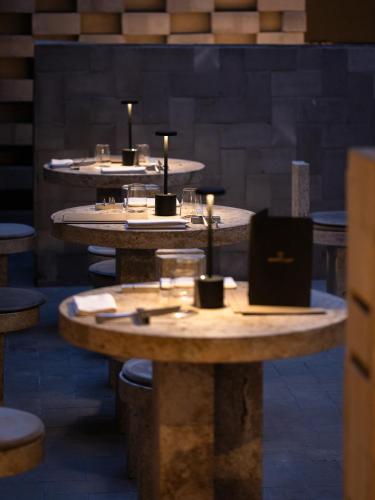 a group of tables with candles on them at Nomos Hotel in Rome