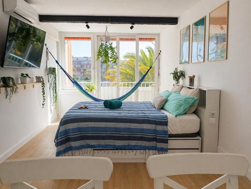 a bedroom with a bed with a hammock in it at La Pineda Pisito Playero in La Pineda