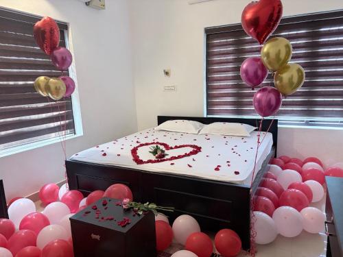 a room with a bed with balloons around it at beach homestay sea view in Kannur