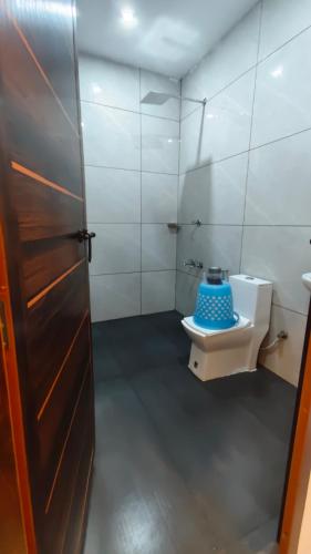 a bathroom with a toilet and a sink at Hill valley farm resort in Munnar