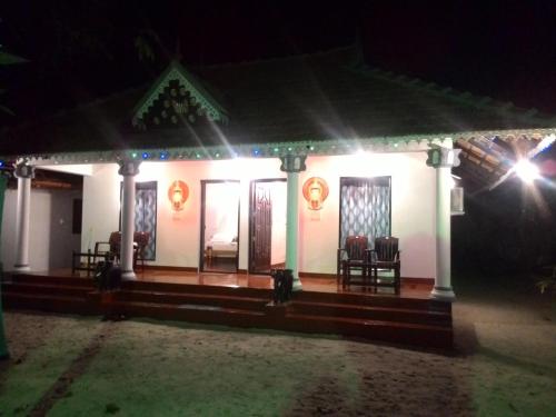 a house lit up at night with lights at Marari Babu Homestay in Mararikulam