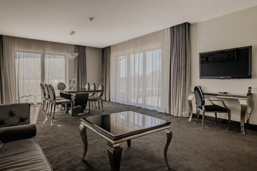 a living room with a couch and a table at Willa Port in Ostróda