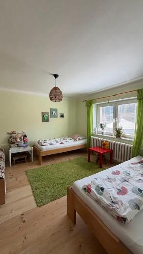 a living room with two beds and a window at Apartmán AZ in Prostřední Bečva