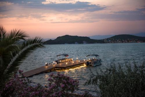 a dock with lights on it in the water at D - Resort Ayvalık in Ayvalık