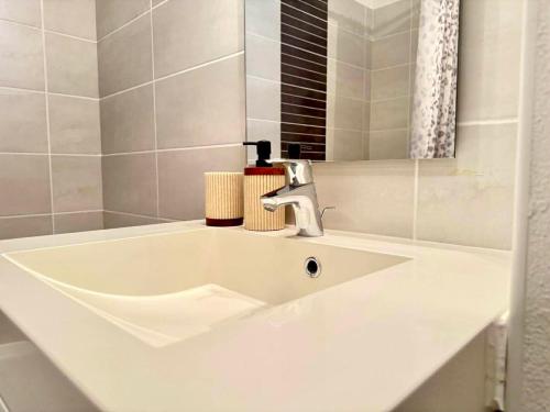 a white sink in a bathroom with a mirror at Charming Tournefeuille House in Tournefeuille