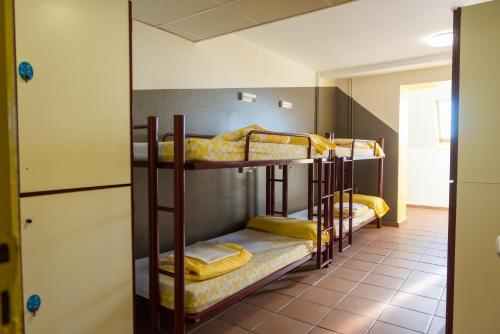 a bunk room with three bunk beds in it at Alberg Núria Xanascat in Queralbs