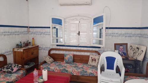 a bedroom with a bed and a window at Charmante maison plage in Soliman