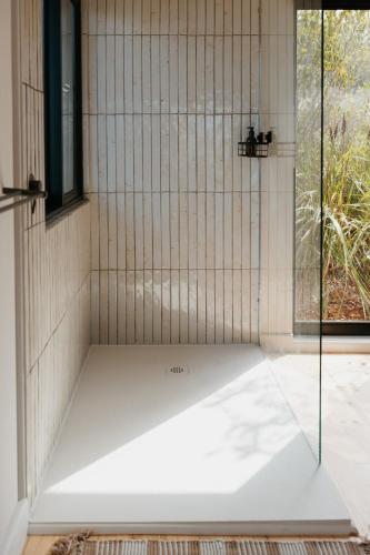 a shower with a glass door in a bathroom at Ocean's Edge - Private Nature Reserve in George