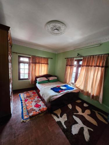 a bedroom with a bed and a rug at Om Raghav Homestay in Kathmandu