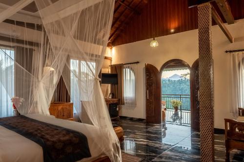 a bedroom with a bed with a mosquito net at Grand Campuhan in Tegalalang