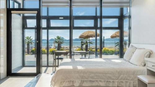 a bedroom with a bed and a view of the ocean at Yeosu Wayo Ocean View Pension in Yeosu