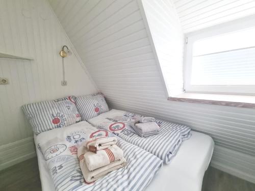 a small room with two beds in a attic at Lütt Hüs 1 in Wenningstedt