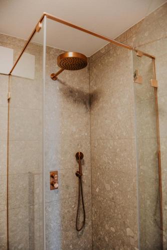 a bathroom with a shower with a shower head at sleepArt beach in Celle