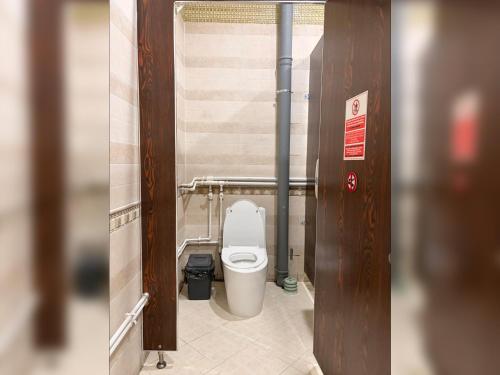 a small bathroom with a toilet in a stall at Hunnu Camp in Arhust