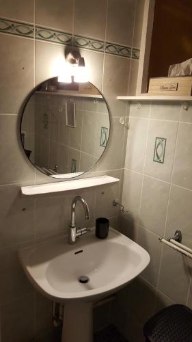 a bathroom with a sink and a mirror at Gîte MAÏ - Classé 3 étoiles in Dieppe