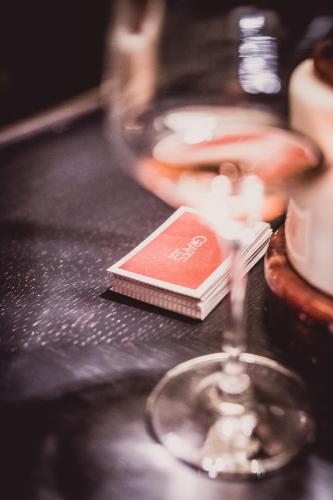 a wine glass with a book on a table at CORTIINA Hotel in Munich