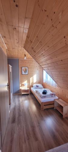 a large room with two beds and a wooden ceiling at Solińskie Podgórze in Solina