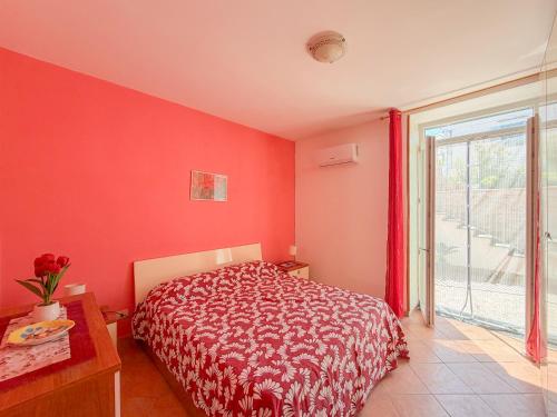 a bedroom with a bed with a red wall at LES PETITES MAISONS Maison rouge in Procida