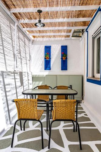 a dining room with a table and chairs at Skiathos Pearl in Skiathos