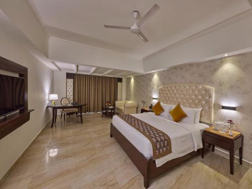 a hotel room with a bed and a television at Grand Continent Premiere - T Nagar in Chennai