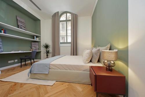 a bedroom with a bed and a desk and a window at CAV Juvarra in Turin